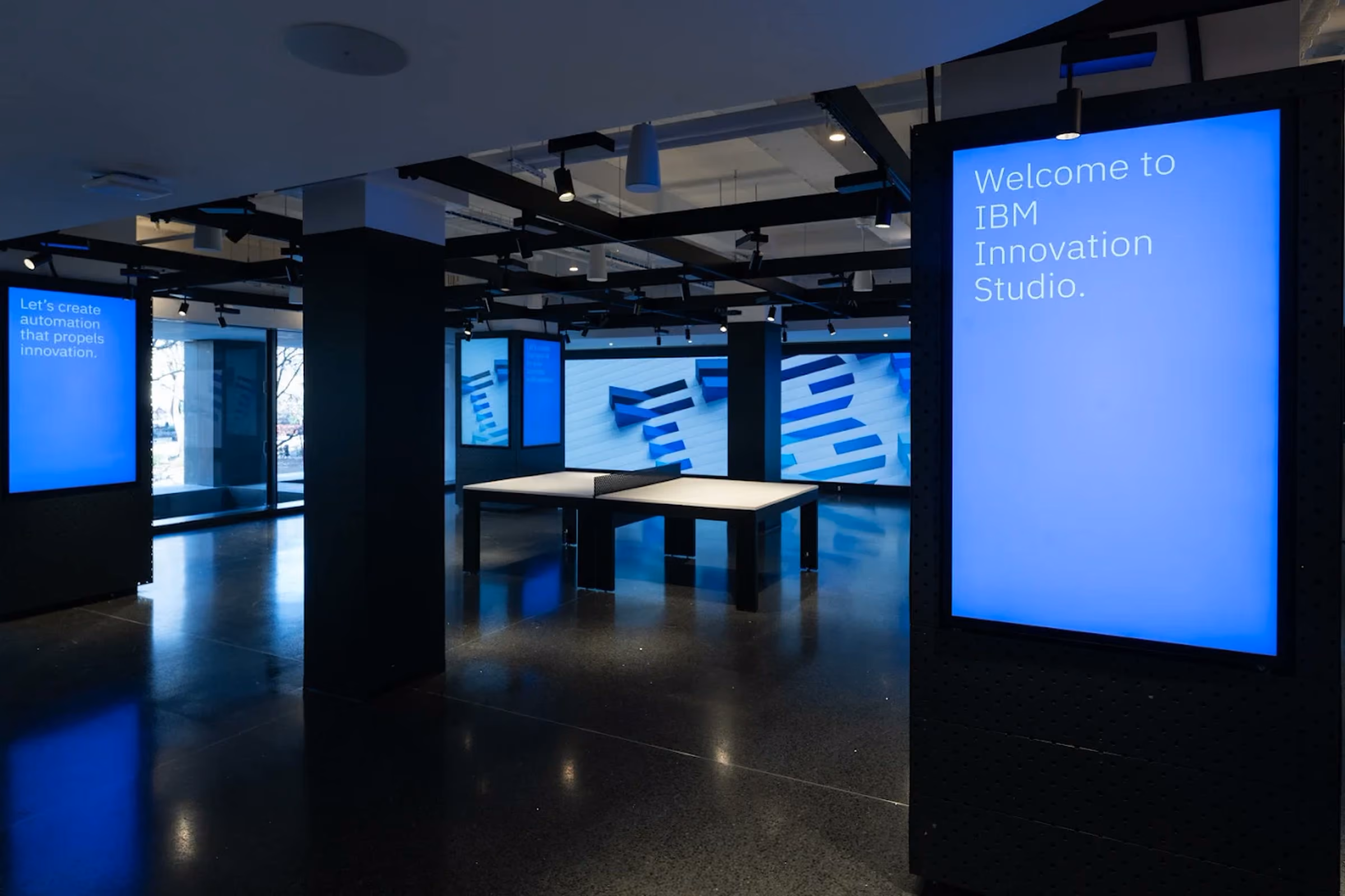 The IBM Innovation Studio floor in New York, with vertical displays and the studio's LED wall lit for an executive visit.