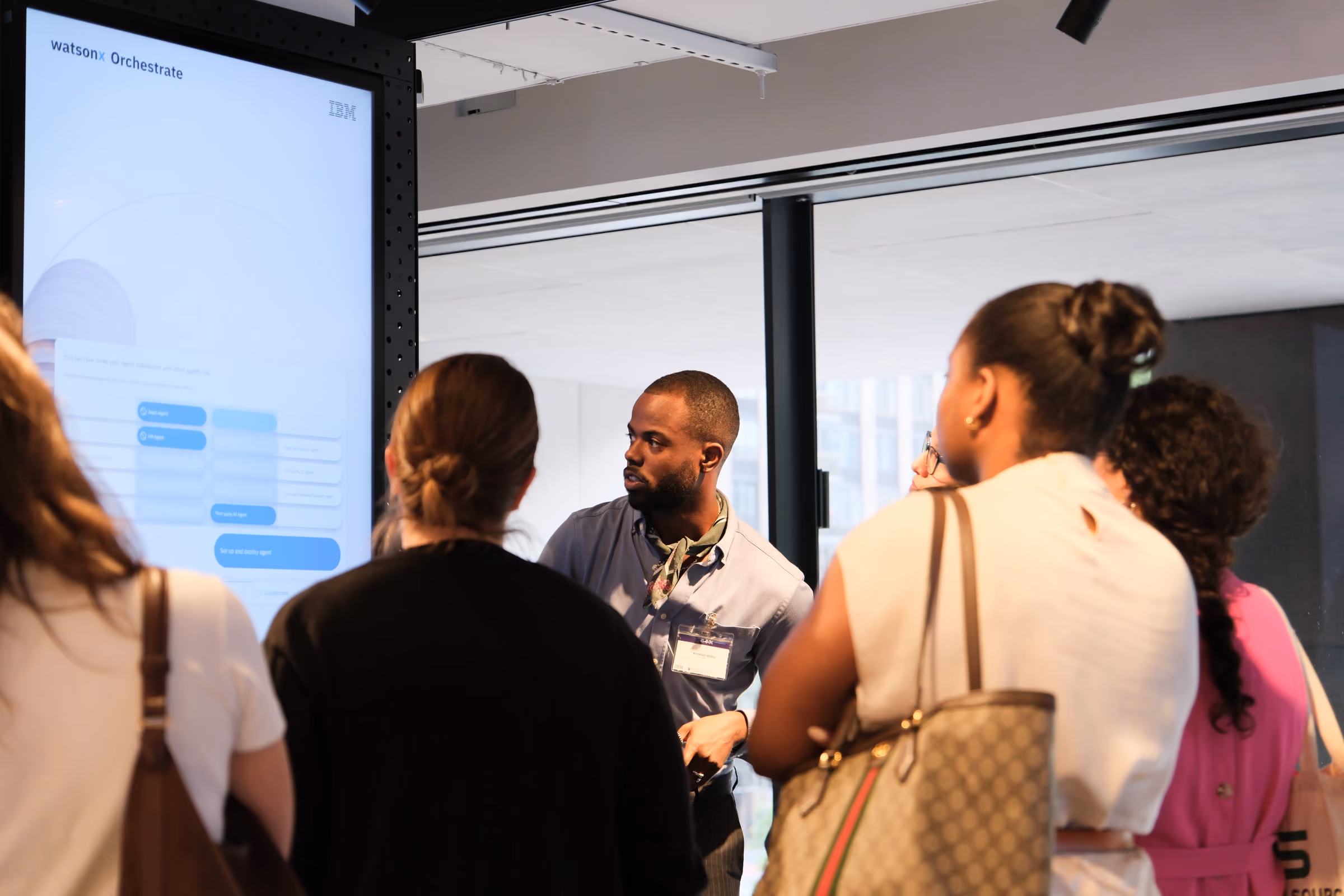 Presenting one of the four interactive touch-screen pillars, running a watsonx Orchestrate demo for attendees.